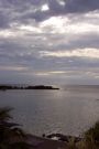 sun trying to break through the clouds in roatan, honduras